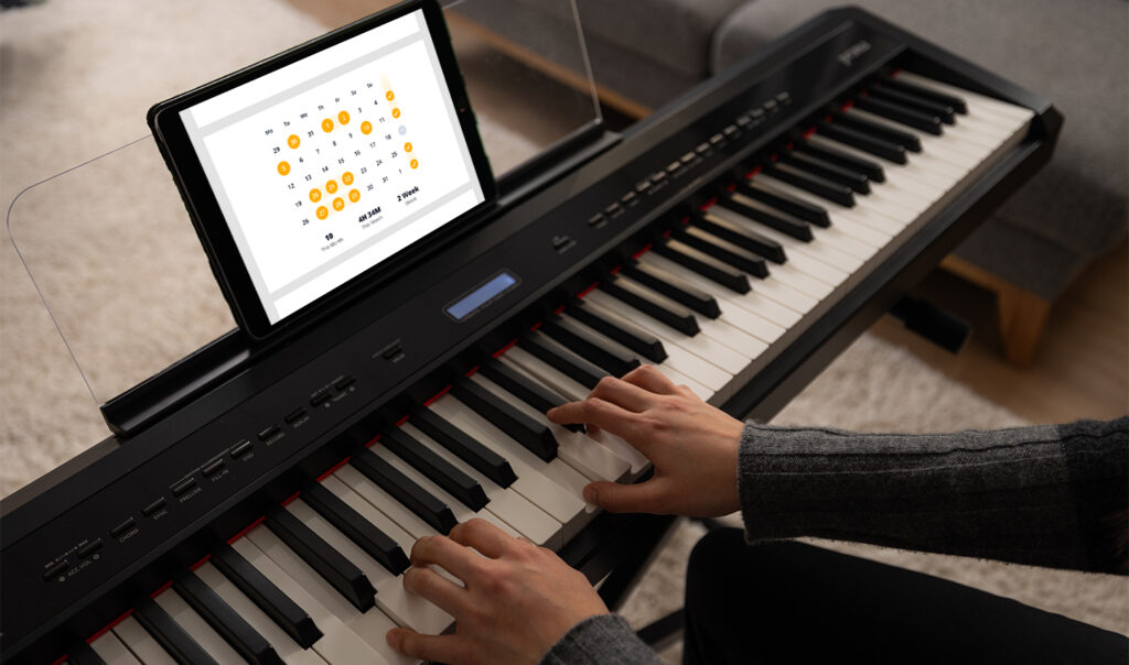 Pianist practicing chords on a digital piano with Practice Tracker on an Ipad